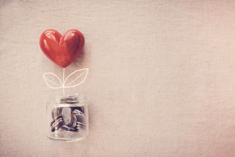 jar of money with a baloon heart