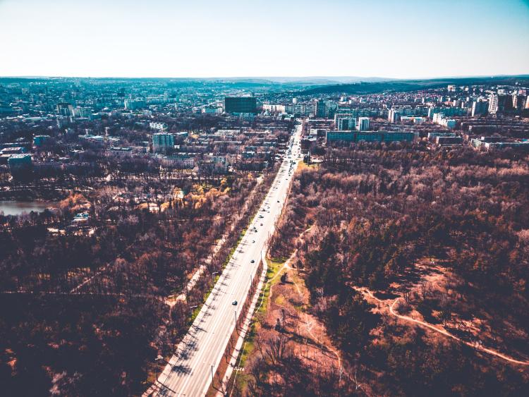 Chișinău, Moldova, picture taken by a drone from the sky, in the foreground a road leading to the city
