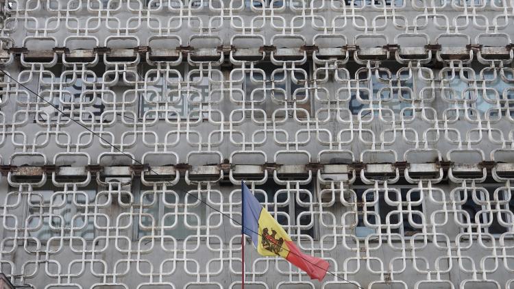 close up of concreet facaed of office building with Modovan flag