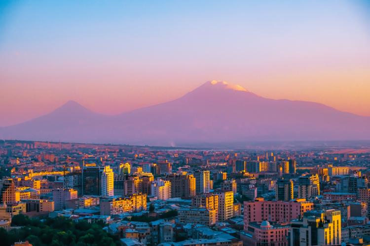 A photo of Yerevan with mountains in the background. 